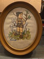 Full view of oval framed embroidered artwork