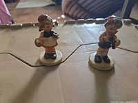 Both figurines on surface showing scale and relative size