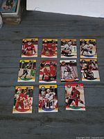 Front view of 11 Pro Set hockey cards spread on table