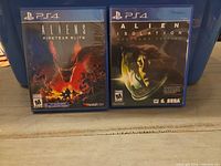 Front view of both PS4 game cases displaying cover art