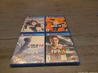 All four PS4 game cases laid out flat