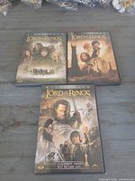 All three DVD cases front covers visible on tabletop
