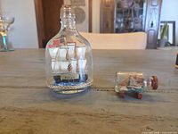 Both ship-in-bottle models side by side on table