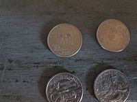 Obverse of 2008 New Mexico quarter and reverse of 2002 Mississippi quarter plus partial view of other coins