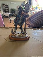 Front view of clown policeman figurine with traffic light and ducks on wood base