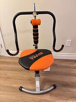 Full view of assembled Ab Doer Twist exercise machine showing seat, mid-section roller, arms and base