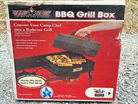 Front of retail box showing Camp Chef BB-100L BBQ Grill Box