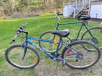 Blue CCM Excel and green Suteki bicycles side view outdoors