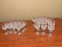All 25 clear crystal goblets in two size groups on tabletop
