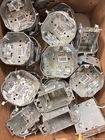 Top view of assorted steel electrical boxes in carton