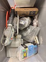 Top view of tote showing trouble light, circuit breaker box, wire roll, outlet box, terminal case, small hardware