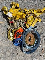 Group of straps, chains and ratchets on ground
