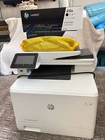 Printer with boxed 410A toner cartridge on top