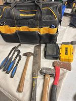 Overall lot with DeWalt bag, battery, charger, hammers, hatchet, machete and pliers