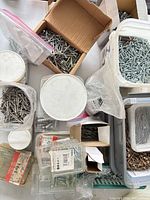 Top view of multiple containers with nails and screws
