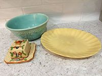 turquoise bowl, yellow plate, covered floral box with underplate