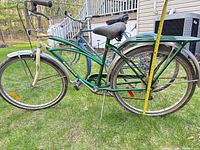 Full view of SuperCycle cruiser with blue Raleigh bike in background