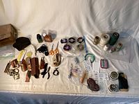 Overview of all sewing, leather and fishing repair items on table