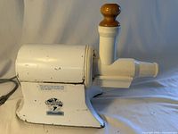 Right side view of Champion juicer assembled with chute and wooden tamper