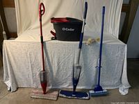 Four cleaning tools and spin bucket displayed front view