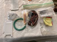 Assorted crafting cord, thread spools, Lexol bottle, scissors and small tools visible (items do not match jar description)