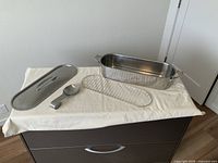 Pan, lid, rack and spoon displayed together