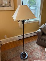 Full view of floor lamp with shade in room