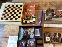 Overview of multi-game board, chess kit box, Sentence Cube Game, poetry cubes and wooden puzzles