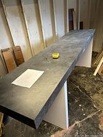 Top view of long grey laminate counter on support legs