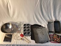 Entire lot laid out showing all bakeware, utensils and scale