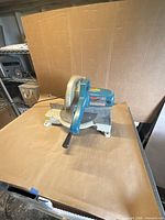 Front-angled view of Makita LS1030 miter saw on table