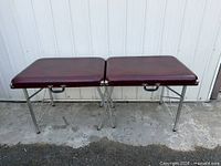Full view of folded-open massage table on outdoor surface