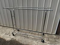 Full front view of chrome garment rack assembled on wheels