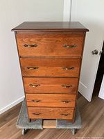 front view of five-drawer dresser on dolly