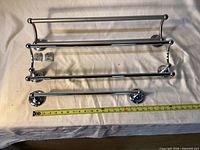 All three towel bars aligned with measuring tape for scale