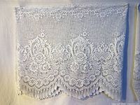 Front view of first lace valance showing floral pattern and scalloped edge