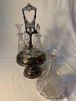 Full view of cruet stand with four bottles mounted and separate faceted decanter
