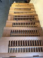 Stack of eight wooden louvered shutters