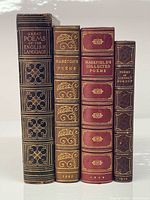 Front view of four leather-bound poetry books showing titles and gilt tooling