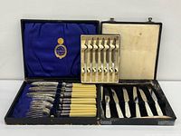 All three boxed cutlery sets opened showing contents