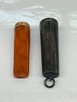 Amber holder and silver case side by side
