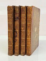 Spine view of four half-leather volumes numbered 1-4 showing binding style and wear