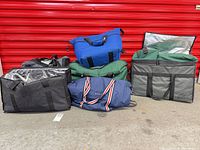 Group shot of nine assorted insulated cooler bags showing colors, sizes and reflective liners