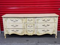 Full frontal view of cream Drexel Heritage eight-drawer dresser