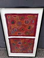 Full view of framed Mola artwork showing two textile panels
