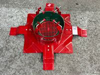 Top view of red steel Christmas tree stand with extended feet
