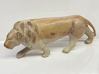 Full left-side view of soapstone lion sculpture