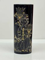 Full front view of black cylindrical vase with gold and grey illustration