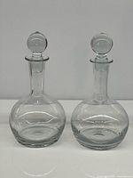 Both decanters side-by-side, stoppers inserted