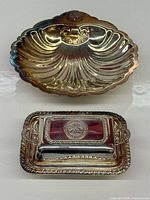 Both silver plated dishes side by side